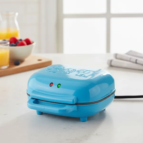 Blue Brentwood TS-253 animal shape waffle maker on a kitchen counter, closed and ready for use.