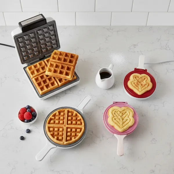 assortment of different waffle makers and various waffle types