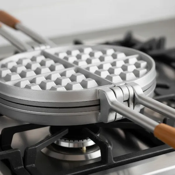 Nordic Ware Stovetop Waffle Iron, cast aluminum, showing deep Belgian waffle pockets and two halves.