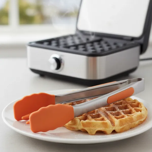 Heat-resistant silicone waffle tongs and fork for gentle, scratch-free removal of delicate waffles.